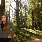 Native American Studies alumna Erica Costa stands in the forest.