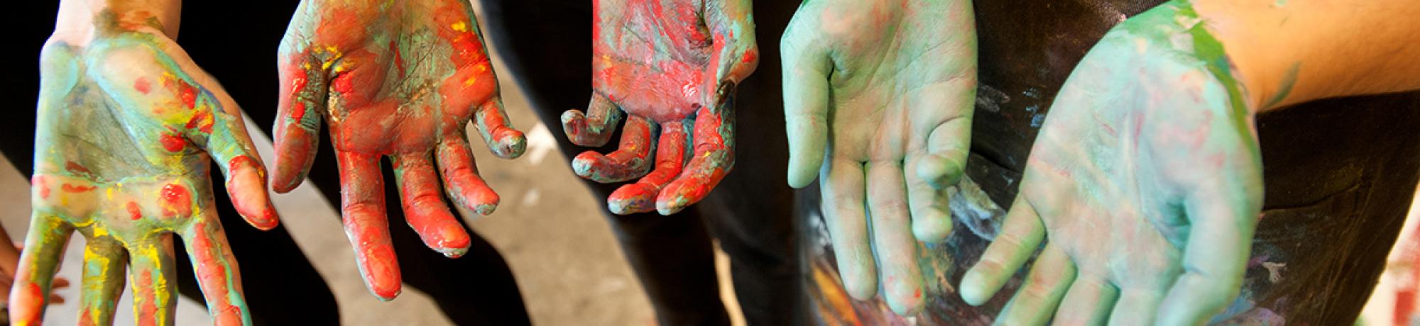 Photo: student hands covered in paint