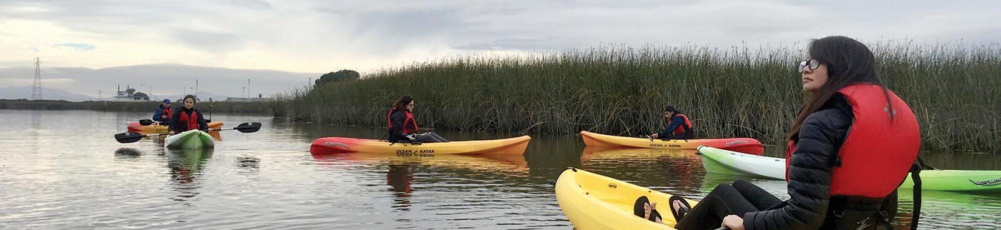 Photo: students kayaking creek
