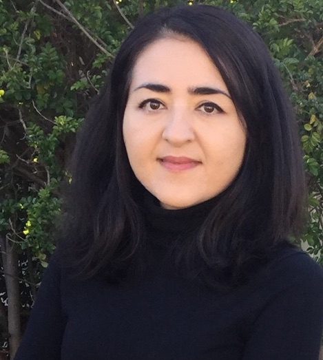 Najwa Mayer looking at the camera in a black turtle neck