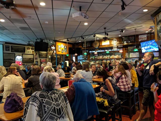 A crowd sits in G Street WunderBar for a Davis Science Cafe