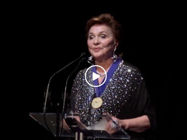 Maria Manetti Shrem wears her UC Davis Medal as she delivers a message to students at commencement