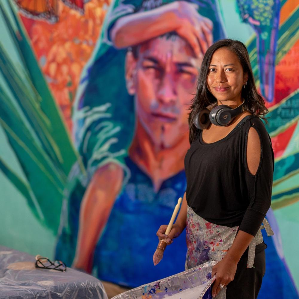 Alicia Marie Siu working on a mural