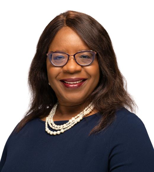 Dean Estella Atekwana in dark blue top with white pearl necklace