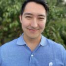 Adil Naurzov wears a blue shirt.