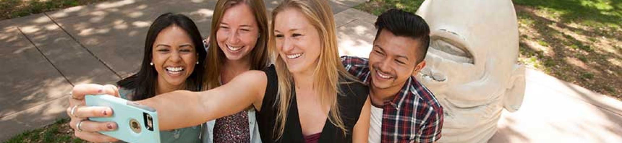 These students from the College of Letters and Science include, from left, Cindy Suzuki, a design major; Hailey Jenkins, a communication major; Lindsey O’Tousa, a psychology major; and Miguel Bagsit, a communication major. They posed at a popular selfie site with the “Eye on Mrak (Fatal Laff)” Egghead. (Gregory Urquiaga/UC Davis)