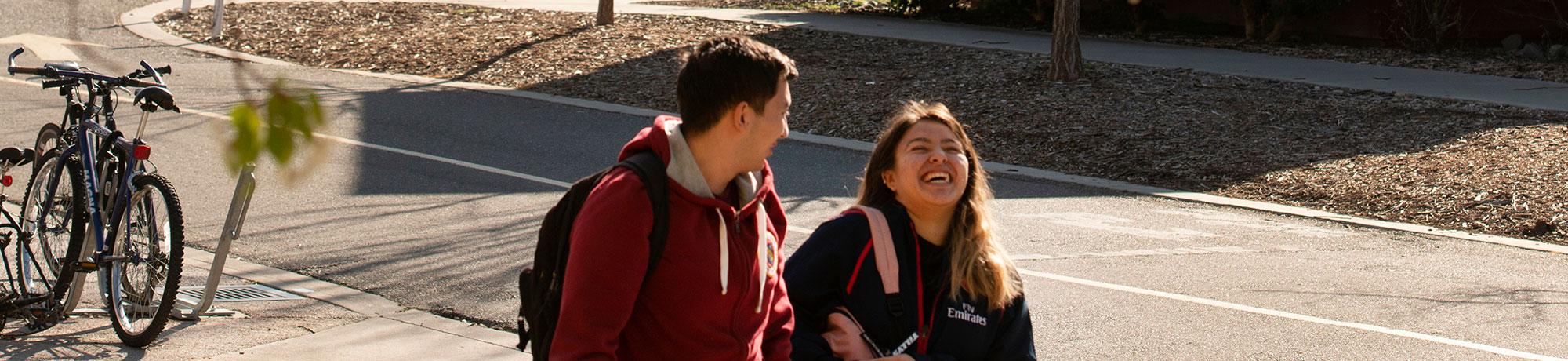 Students walking and laughing together at UC Davis.